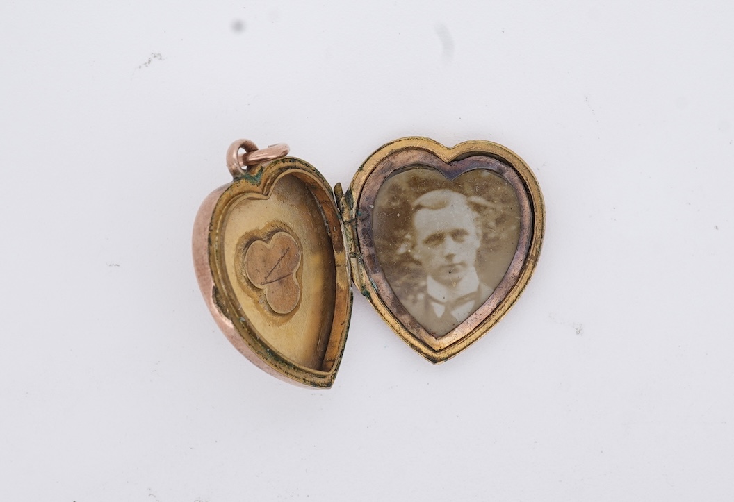 A Victorian yellow metal, amethyst and garnet cluster set brooch, 22mm, an early 20th century yellow metal and seed pearl set heart shaped locket, a yellow metal, garnet and zircon set three stone bar brooch and a tortoi